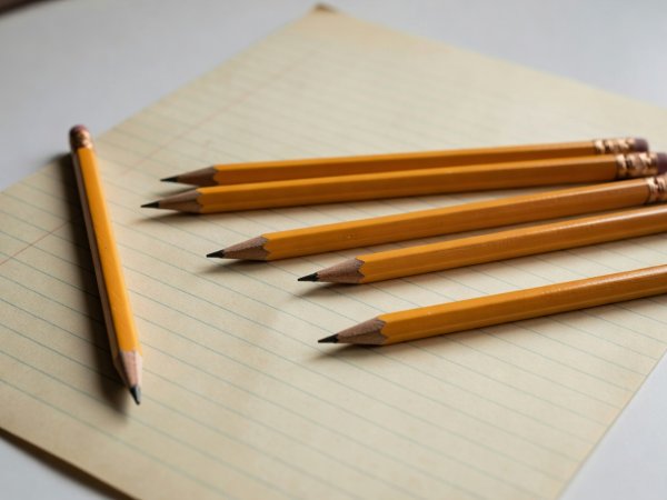 Pencils resting on vintage lined paper